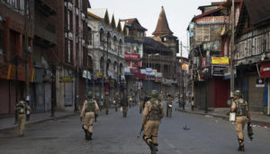 Indian paramilitary soldiers patrol a deserted street during curfew in Srinagar, Indian controlled Kashmir, Tuesday, Sept. 13, 2016. Security forces fired tear gas and shotgun pellets to quell protesters in several places, as a security lockdown marred Eid festivities in the troubled region. Shops and businesses were closed, with a curfew in effect in the entire Kashmir Valley. (AP Photo/Dar Yasin)